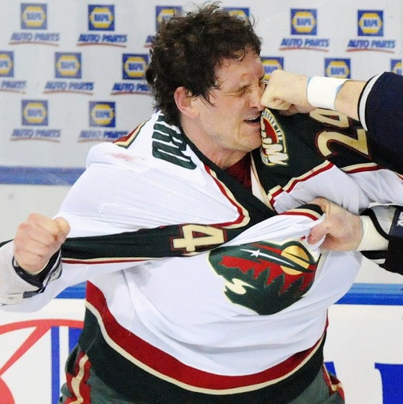 FILE - This Jan. 30, 2009, file photo shows Minnesota Wild left wing Derek Boogaard (24) getting hit by Edmonton Oilers left wing Steve MacIntyre (33) in a fight during first period NHL hockey action  ...