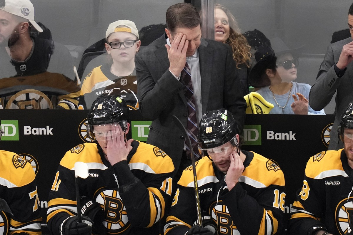 Boston Bruins interim head coach Joe Sacco wipes his forehead during the first period of an NHL hockey game against the Toronto Maple Leafs, Tuesday, Feb. 25, 2025, in Boston. (AP Photo/Charles Krupa)