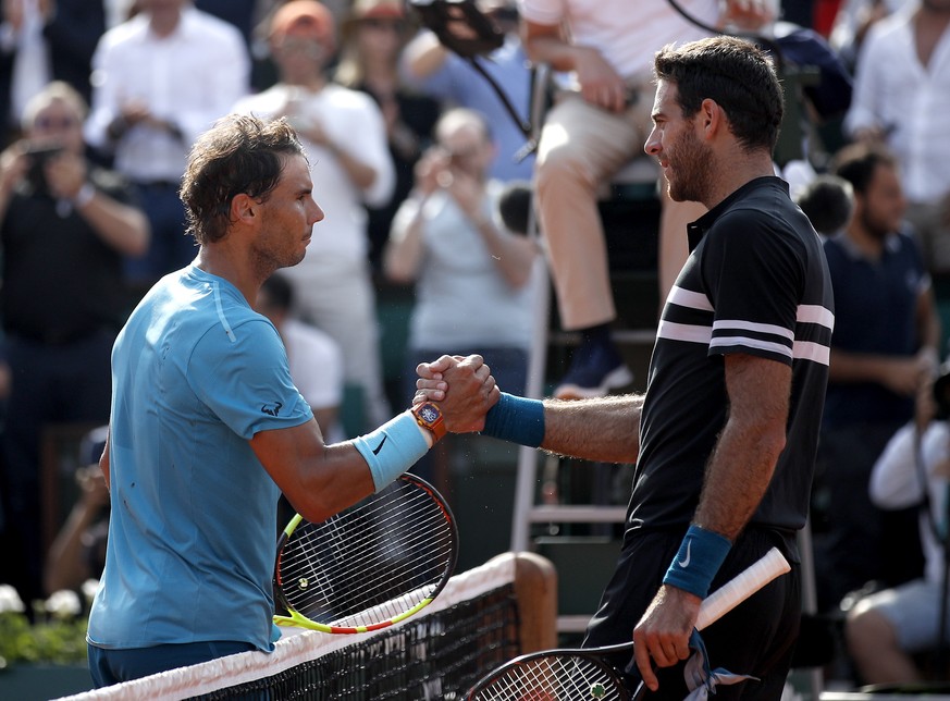 epa06794329 Rafael Nadal of Spain (L) reacts with Juan Martin Del Potro of Argentina after winning their men’s semi final match during the French Open tennis tournament at Roland Garros in Paris, Fran ...