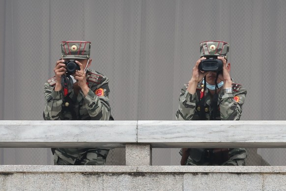epa11281264 North Korean soldiers look towards the South side while US ambassador to the United Nations Linda Thomas-Greenfield visits the truce village of Panmunjom in the Demilitarized Zone (DMZ) di ...