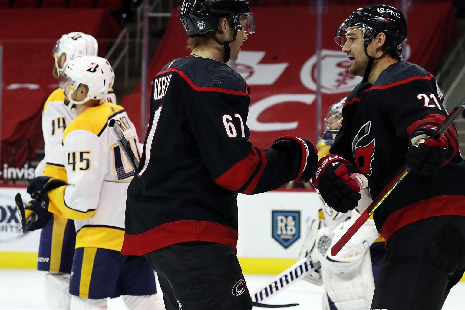 Carolina Hurricanes' Morgan Geekie (67) is congratulated by Nino Niederreiter (21) after his second goal of the night, during the second period of the team's NHL hockey game against the Nashville Pred ...