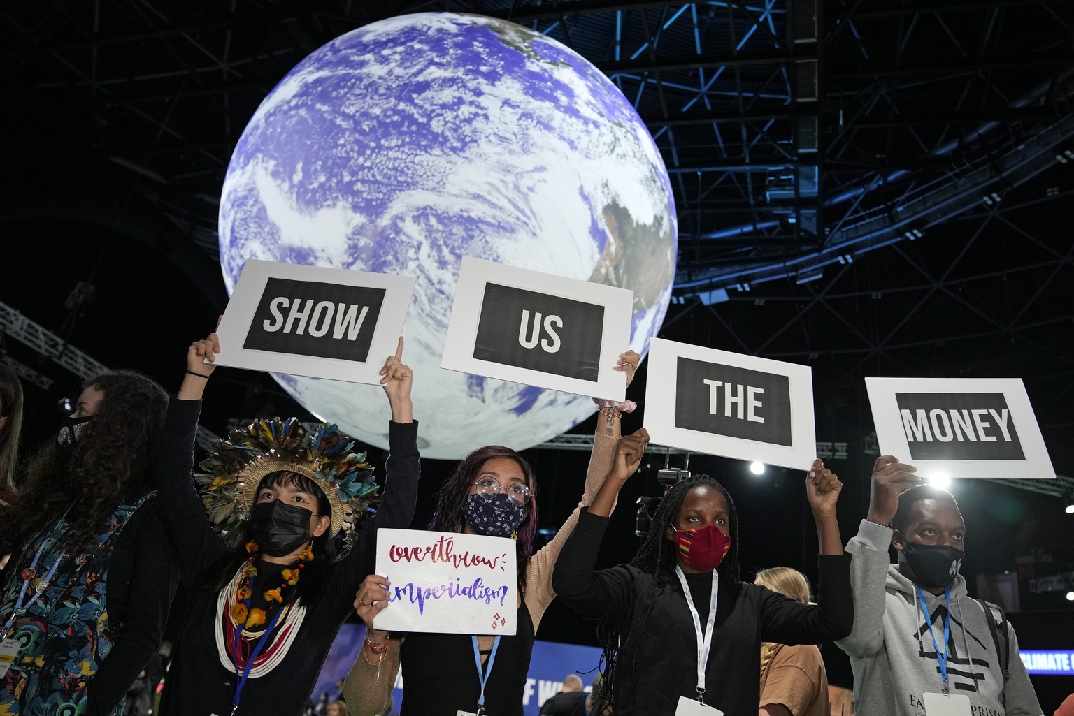 Climate activist Vanessa Nakate, second right, and other activists engage in a &#039;Show US The Money&#039; protest at the COP26 U.N. Climate Summit in Glasgow, Scotland, Monday, Nov. 8, 2021. The U. ...