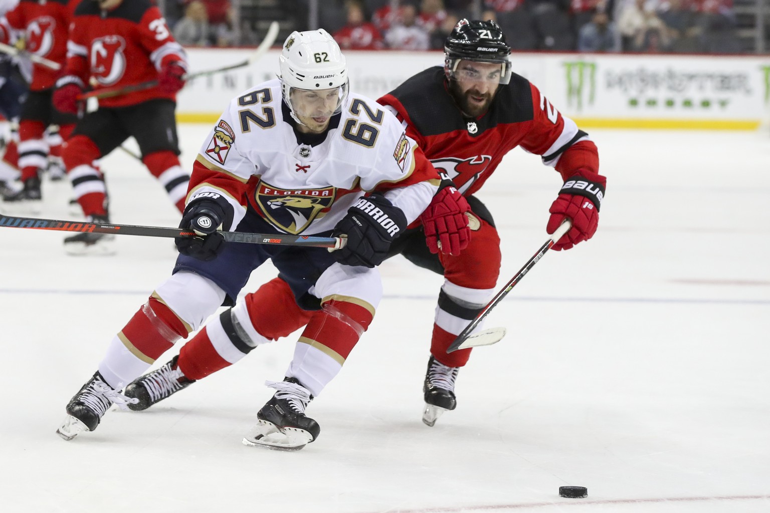 Florida Panthers center Denis Malgin (62) skates against New Jersey Devils center Kyle Palmieri (21) during the third period of an NHL hockey game, Monday, Oct. 14, 2019, in Newark, N.J. The Panthers  ...