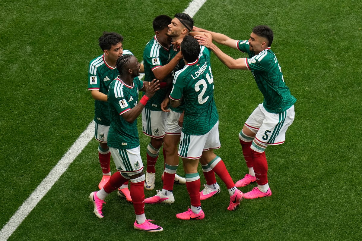 Mexico's Raul Jimenez celebrates with team mates after scoring his side's second goal during the World Cup Group A soccer match between Mexico and South Africa in Mexico City, Thursday, June ...