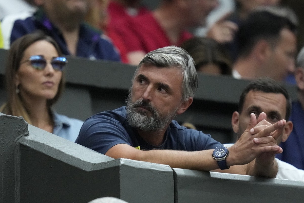 Goran Ivanisevic, the coach, and Jelena Djokovic, the wife, of Serbia's Novak Djokovic watch as he plays Poland's Hubert Hurkacz in a men's singles match on day seven of the Wimbledon t ...