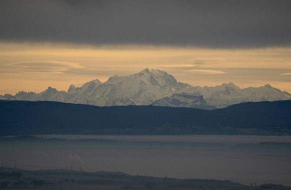 The Mont Blanc is seen behind the foggy plains around Lyon, central France, Tuesday, Nov. 26, 2019. (AP Photo/Laurent Cipriani)