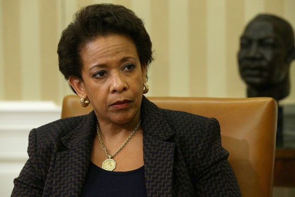 WASHINGTON, DC - MAY 29:  U.S. Attorney General Loretta Lynch listens to President Barack Obama as he delivers remarks to reporters after a meeting in the Oval Office at the White House May 29, 2015 in Washington, DC. The first African-American woman to head the Justice Department, Lynch announced this week a major corruption investigation into FIFA, the world's largest soccer organizing body.  (Photo by Chip Somodevilla/Getty Images)