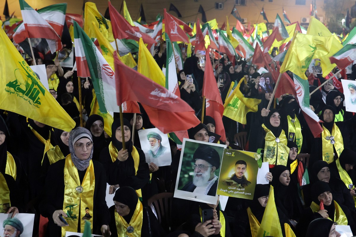 epa13099078 Supporters of Hezbollah carry Iranian and Hezbollah flags during a memorial ceremony for the late Supreme Leader Ali Khamenei in the southern suburbs of Beirut, Lebanon, 08 July 2026. On 0 ...
