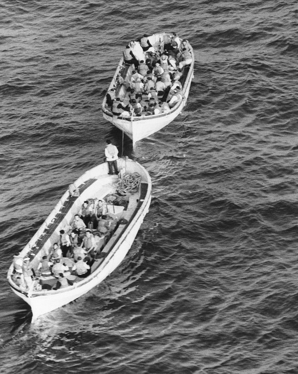 The captain and crewmen, who stayed with him until almost the end, head for rescue ship in lifeboats from the Italian luxury liner Andrea Doria, July 26, 1956. The vessel sank after collision with the ...