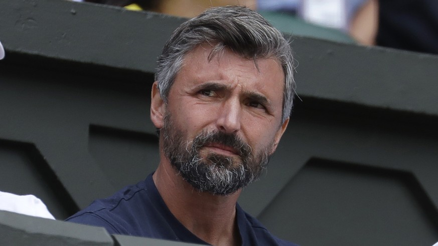 FILE - This July 1, 2019, file photo shows former Wimbledon champion Goran Ivanisevic watching a men&#039;s singles match between Novak Djokovic and Philip Kohlschreiber at the Wimbledon Tennis Champi ...