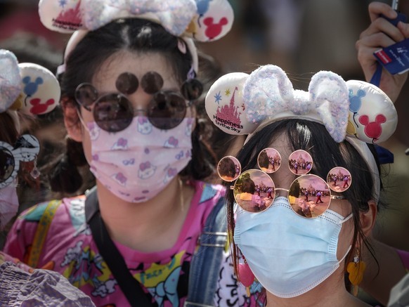 epa10042642 Visitors enter Shanghai Disneyland as it reopens after the COVID-19 lockdown, in Shanghai, China, 30 June 2022. Following three months of pandemic-mandated closure, Shanghai Disneyland reo ...