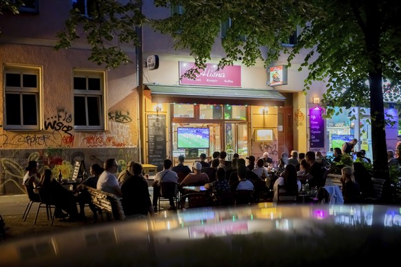 Guests at a Turkish restaurant near the Schlesisches Tor in Berlin-Kreuzberg watch the Euro 2020 opening game between Turkey and Italy on television, in Berlin, Germany, Friday, June 11, 2021. (Christ ...