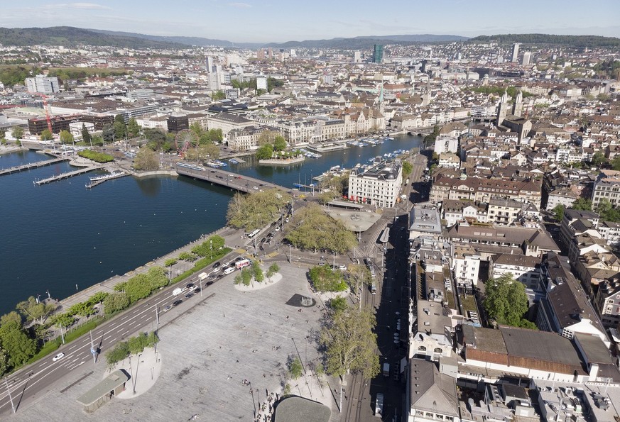 Drone image of Sechselaeutenplatz square, center bottom, Bellevue square with the tram stop &quot;Bellevue&quot;, image center, and the Quaibruecke bridge which spans over the estuary of lake Zureich  ...