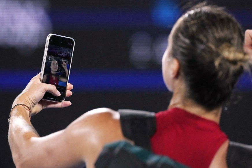 Aryna Sabalenka of Belarus takes a selfie on a mobile phone after defeating Amanda Anisimova of the U.S. in their fourth round match at the Australian Open tennis championships at Melbourne Park, Melb ...
