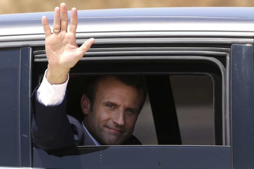 French President Emmanuel Macronwaves from his car after visiting the Istres air base, southern France, Thursday, July 20, 2017. Macron is visiting nuclear forces as he tries to show his commitment to ...