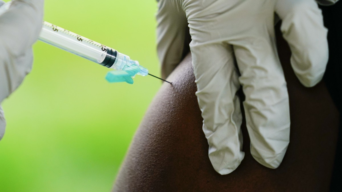 FILE - A health worker administers a dose of COVID-19 vaccine during a vaccination clinic in Reading, Pa. On Friday, April 7, 2023, The Associated Press reported on stories circulating online incorrec ...