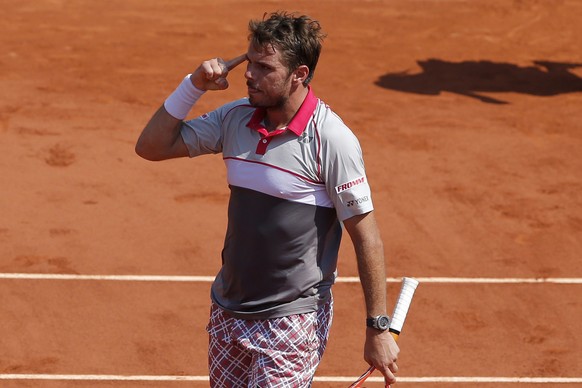 Switzerland's Stan Wawrinka reacts as he wins the third set against France's Jo-Wilfried Tsonga during their semifinal match of the French Open tennis tournament at the Roland Garros stadium ...
