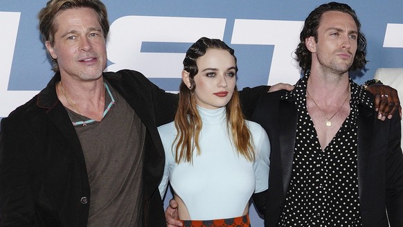 Brad Pitt left, Joey King and Aaron Taylor-Johnson pose for photographers upon arrival at the premiere of the film 'Bullet Train' in London, Wednesday, July 20, 2022. (Photo by Scott Garfitt/Invision/ ...