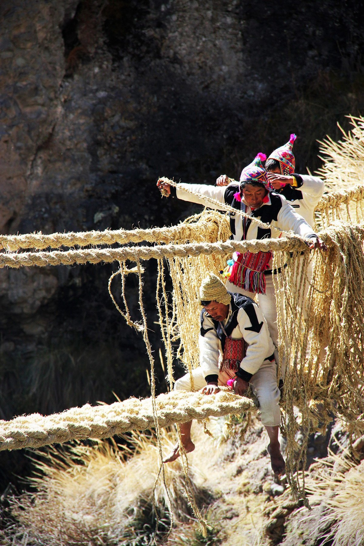 epa04245985 A undated handout photo releaded on 08 June 2014 by Peruvian Culture Ministry shows Peruvian indigenous working on the suspension bridge Q'eswachaka in Cuzco region, Peru. UNESCO deli ...