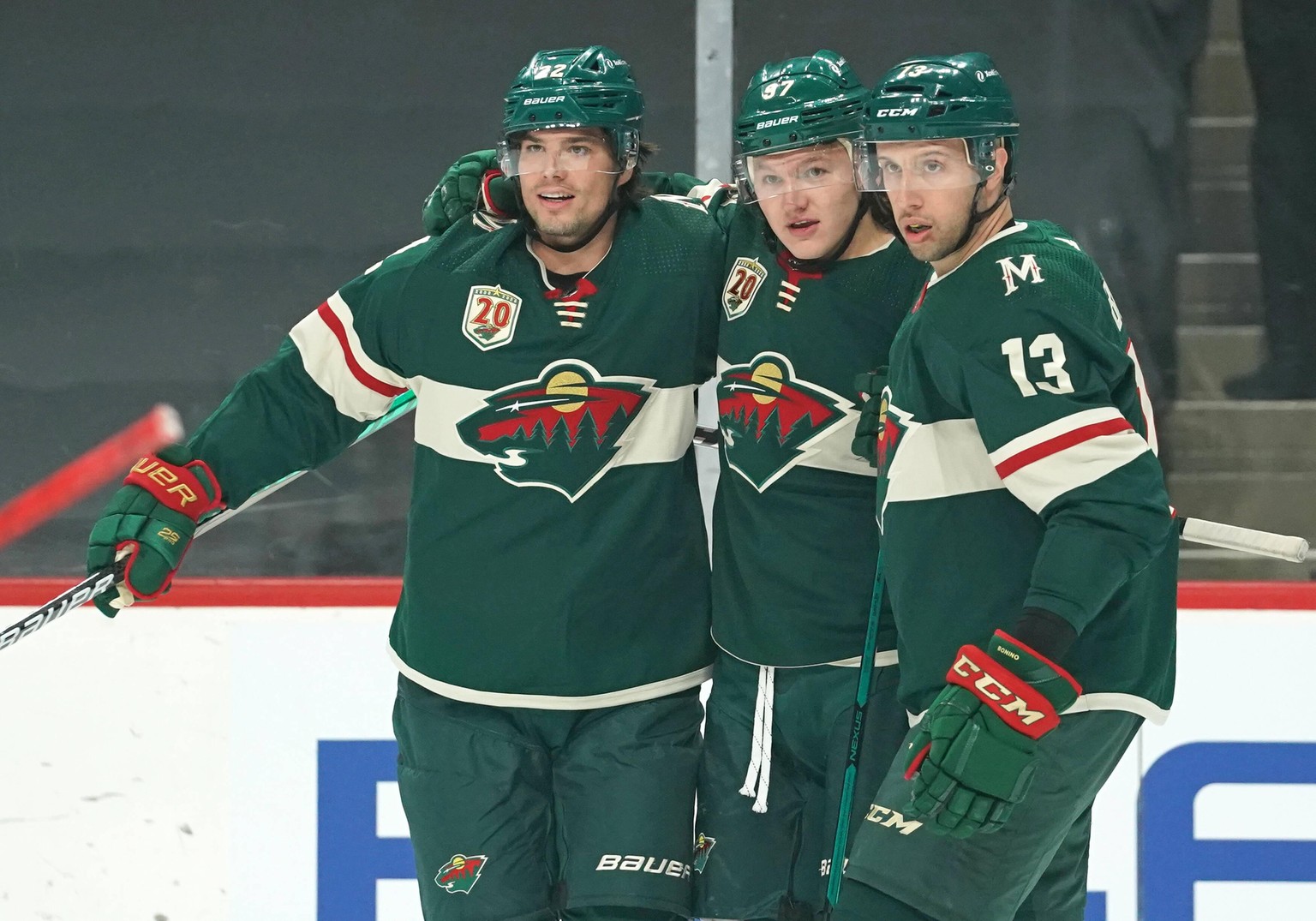 ST. PAUL, MN - APRIL 07: Minnesota Wild Right Wing Kirill Kaprizov 97 celebrates his 1st period power play goal with Minnesota Wild Right Wing Kevin Fiala 22 and Minnesota Wild Center Nick Bonino 13 d ...