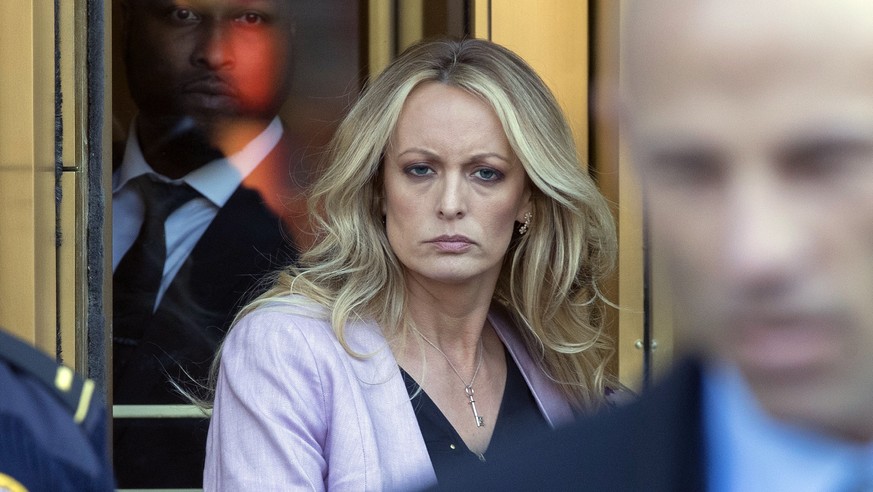 Adult film actress Stormy Daniels, left, follows her attorney Michael Avenatti, right, as she leaves federal court, Monday, April 16, 2018, in New York. (AP Photo/Mary Altaffer)