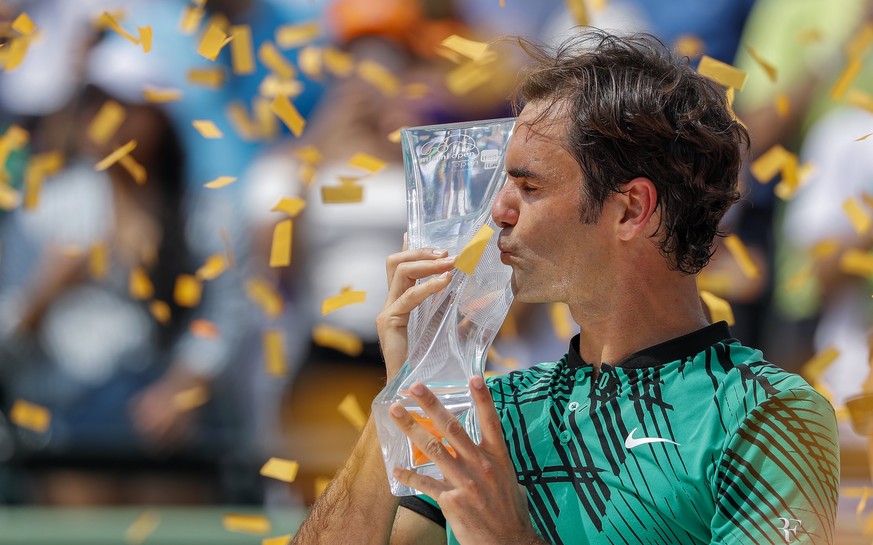 epa05885051 Roger Federer of Switzerland kisses the winner&#039;s trophy after defeating Rafael Nadal of Spain in the men&#039;s singles final match at the Miami Open tennis tournament on Key Biscayne ...