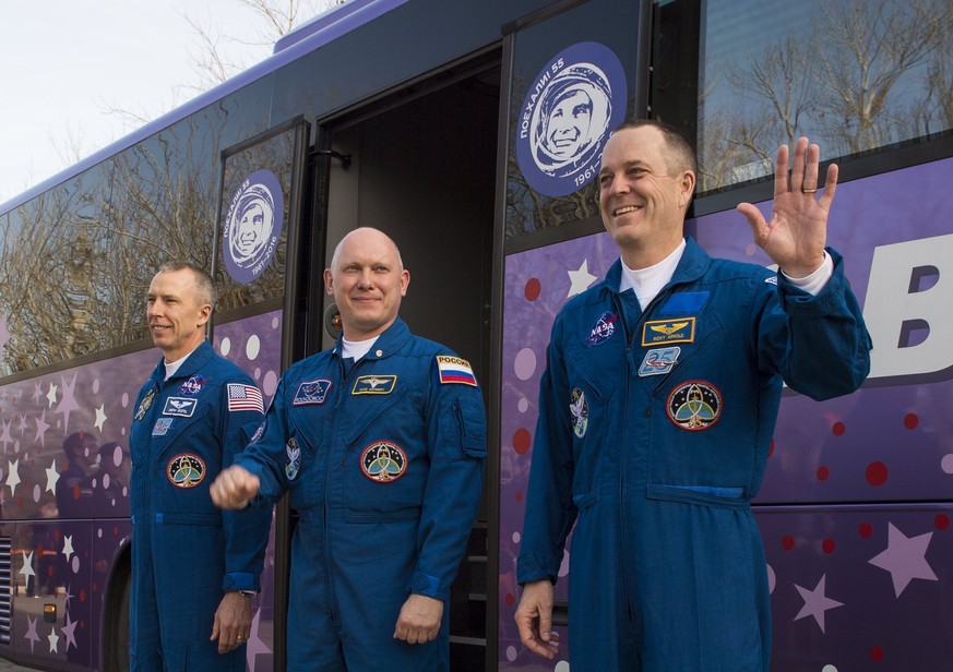 epa06618441 A handout photo made available by the NASA on 21 March 2018 shows Expedition 55 flight engineer Drew Feustel of NASA, left, Soyuz Commander Oleg Artemyev of Roscosmos, center, and flight e ...