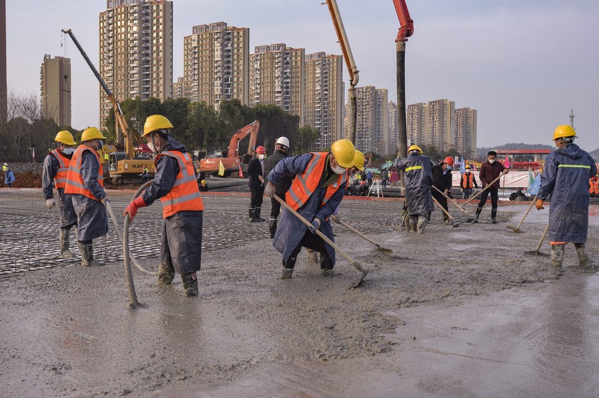 In this Tuesday, Jan. 28, 2020, photo, construction workers labor at the site of the Huoshenshan temporary field hospital being built in Wuhan in central China&#039;s Hubei Province. China as of Wedne ...