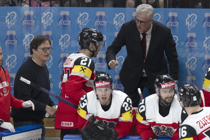 Austria?s head coach Roger Bader, right, and assistant coach Arno Del Curto, left, react during the Ice Hockey World Championship group A preliminary round match between Switzerland and Austria in Pra ...