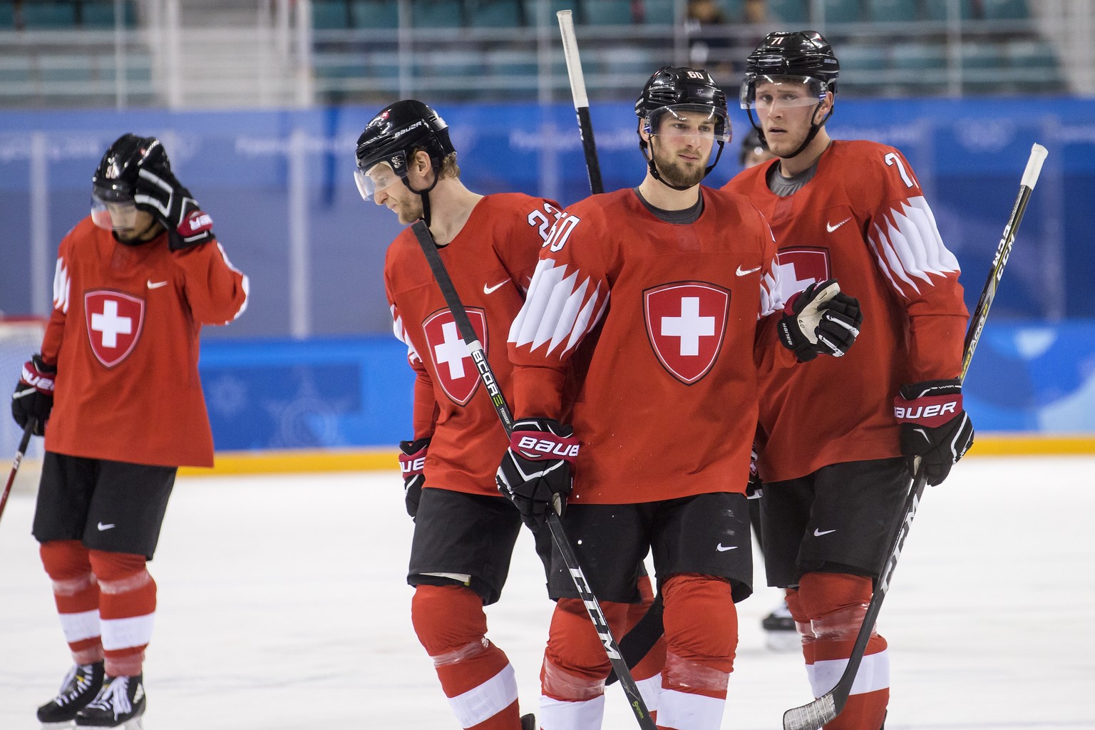 Eric Blum of Switzerland, Simon Bodenmann of Switzerland, Tristan Scherwey of Switzerland, and Enzo Corvi of Switzerland, from left, during the men ice hockey preliminary round match between Switzerla ...