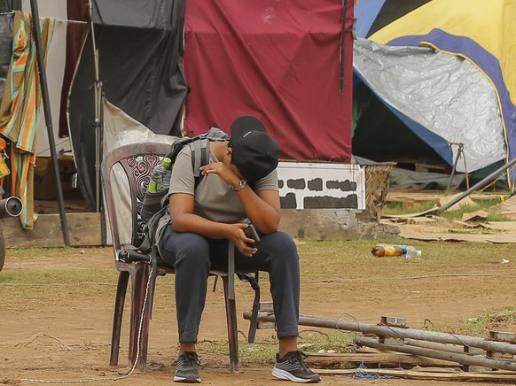 epa10107040 A Protester reacts while they prepare to vacate the months-long makeshift protest site near the Presidential Secretariat in Colombo, Sri Lanka, 05 August 2022. The Colombo Fort Police has  ...