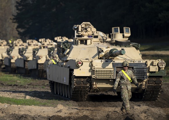 A member of the US Army&#039;s 1st Armoured Battalion of the 9th Regiment, 1st Division from Fort Hood in Texas walks near Abrams battle tanks after arriving at the Pabrade railway station some 50 km  ...