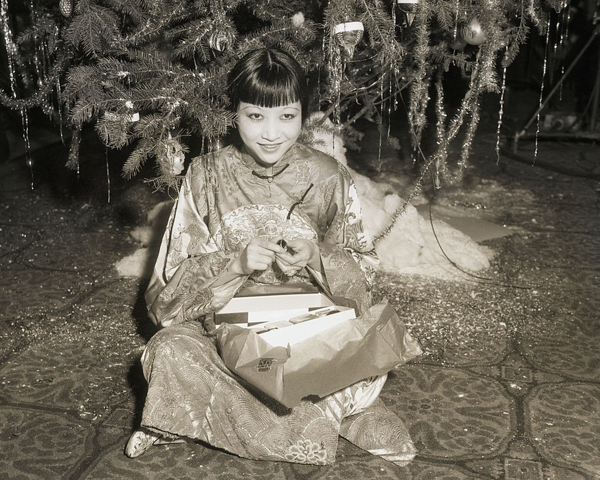 (Original Caption) 12/30/1932-Hollywood, CA- Anna May Wong, pretty Chinese actress, is seen here during the gathering of International film stars at the Christmas tree celebration in the Christy Hotel ...