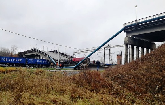 In this photo provided by Amur&#039;s region Russian Emergency Situations Ministry, a truck is seen on a road bridge that collapsed on the Trans-Siberian Railway, in Svobodny, Far Eastern Amur Region, ...