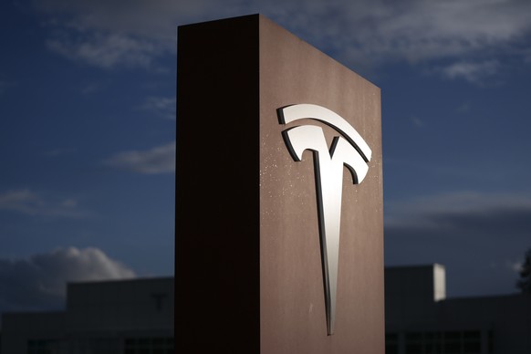 A sign for Tesla is displayed at a facility on Wednesday, April 15, 2026, in Portland, Ore. (AP Photo/Jenny Kane)
US Energy Crisis Electric Vehicles