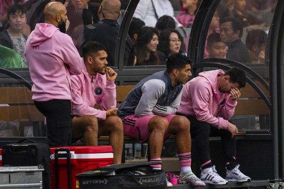 Inter Miami&#039;s Lionel Messi, right, reacts from the bench during the friendly football match between Hong Kong Team and US Inter Miami CF at the Hong Kong Stadium in Hong Kong, Sunday, Feb. 4, 202 ...