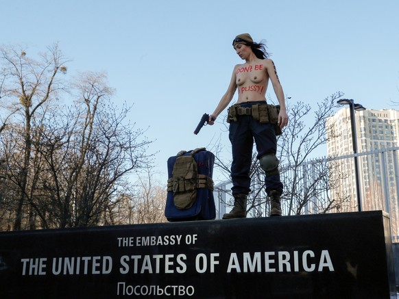 epa09758956 An activist of the women&#039;s movement FEMEN poses during her performance in front of the embassy in Kiev, Ukraine, 15 February 2022. The FEMEN activist holds her rally to denounce diplo ...