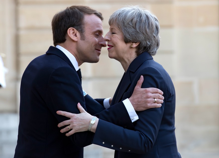 epa07494375 French President Emmanuel Macron (L) greets British Prime Minister Theresa May (R) as she arrives for a meeting at the Elysee Palace in Paris, France, 09 April 2019. British Prime Minister ...