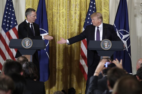 President Donald Trump reaches to shakes hands with NATO Secretary General Jens Stoltenberg during a news conference in the East Room of the White House in Washington, Wednesday, April 12, 2017. (AP P ...