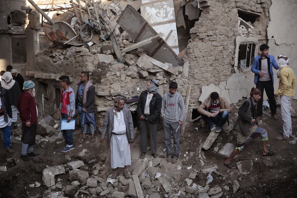 FILE - People gather at the site of a Saudi-led airstrike near Yemen&#039;s Defense Ministry complex in Sanaa, Yemen, Saturday, Nov. 11, 2017. The world must not lose sight of the plight of those livi ...