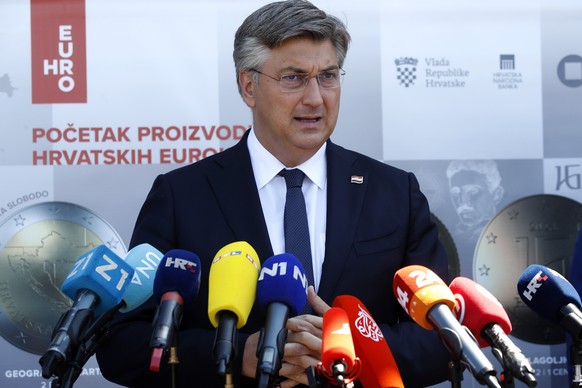 epa10077581 Croatian Prime Minister Andrej Plenkovic speaks at a press conference on the first day minting Croatian euro coins near Zagreb, Croatia, 18 July 2022. EU finance ministers on 12 July signe ...