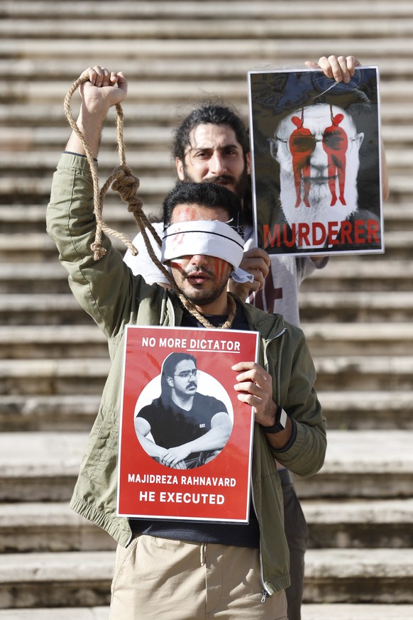epa10368672 Demonstrators from the Iranian-Portuguese community protest in front of the parliament building after Iran's death sentence and public execution of two young protesters, Mohse ...