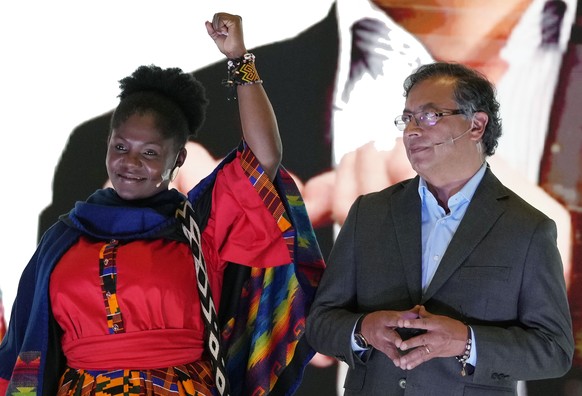 Francia Marquez raises her arm next to Gustavo Petro, presidential candidate with the Historical Pact Coalition, right, during an event presenting her as his running mate in Bogota, Colombia, Wednesda ...