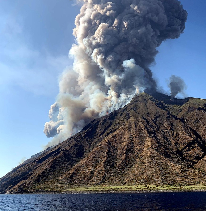 epaselect epa07692558 Ash rises into the sky after a volcano eruption on a small island of Stromboli, Italy, 03 July 2019. According to reports, the island of Stromboli was hit by a set of violent vol ...