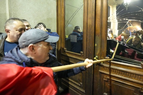 Opposition supporters attempt to enter the capital&#039;s city council building in protest of what election observers said were widespread vote irregularities during a general election last weekend in ...