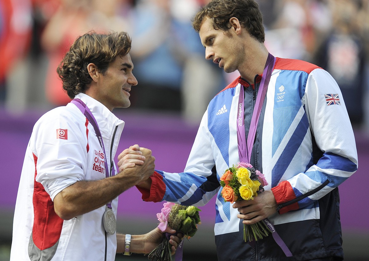 epa07274376 (FILE) - Switzerland's Roger Federer (L) shakes hands with Britain's Andy Murray (R) during the medals ceremony after the men's singles gold medal match against Britain' ...