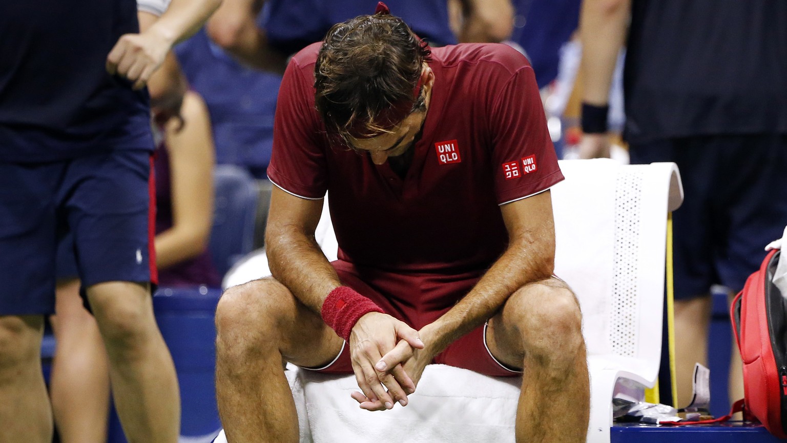 Roger Federer, of Switzerland, sits in front of a fan during a changeover in his match against John Millman, of Australia, during the fourth round of the U.S. Open tennis tournament early Tuesday, Sep ...