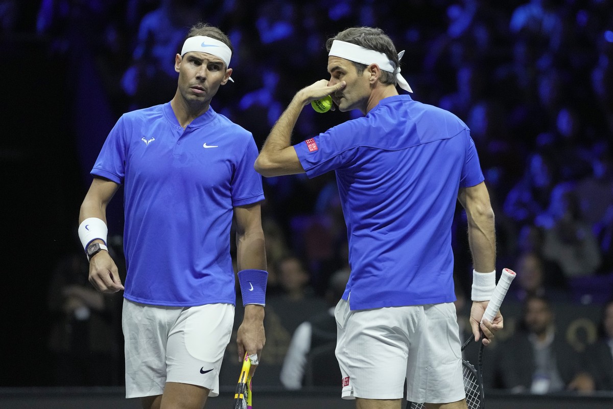 Team Europe's Roger Federer, right, and Rafael Nadal chat during their Laver Cup doubles match against Team World's Jack Sock and Frances Tiafoe at the O2 arena in London, Friday, Sept. 23,  ...