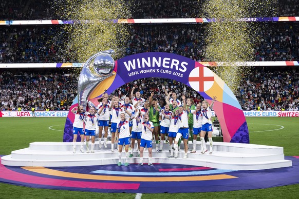 KEYPIX - England Women's Team players celebrate with trophy in the podium ceremony after winning the UEFA Women's EURO 2025 final soccer match between England and Spain at the St. Jakob-Park ...