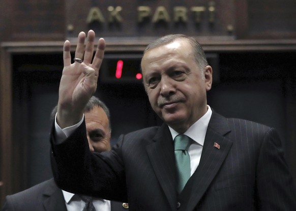 Turkey&#039;s President and leader of ruling Justice and Development Party Recep Tayyip Erdogan salutes as he addresses the members of his ruling party at the parliament in Ankara, Turkey, Tuesday, Fe ...